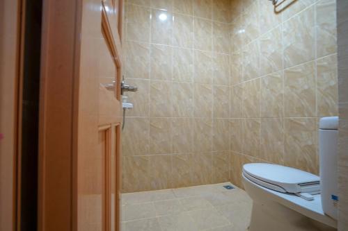 a bathroom with a toilet and a shower at OYO Life 2502 Syariah Triantama Kost in Palembang