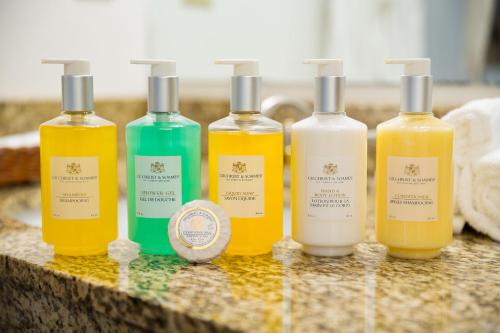 a group of four bottles of soap on a counter at The Marina Inn in Anacortes