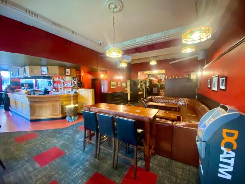 a restaurant with a bar with chairs and a counter at Law Courts Hotel in Dunedin
