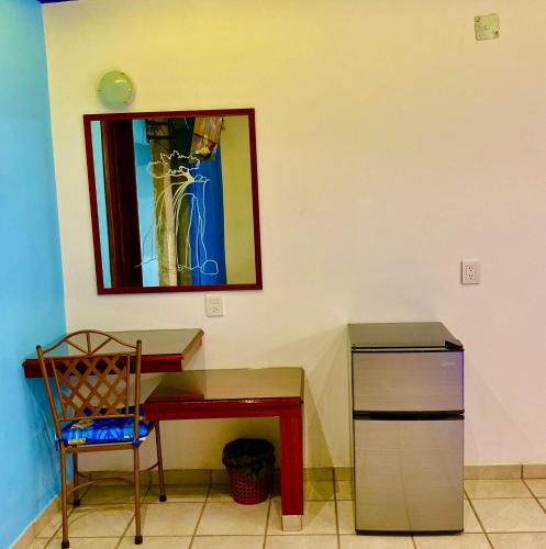 a desk with a chair and a mirror on a wall at Hotel Boutique TEKALI INN in Cuetzalán del Progreso
