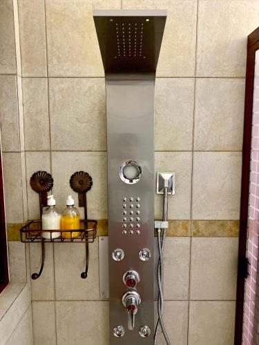 a shower with a shower head in a bathroom at Hotel Boutique TEKALI INN in Cuetzalán del Progreso