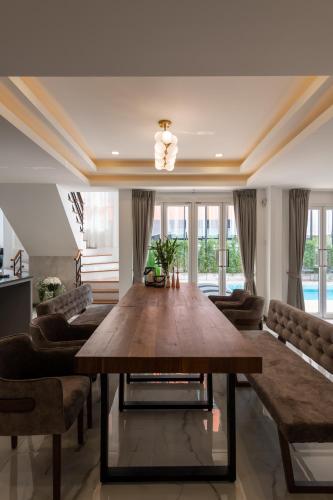 a large dining room with a large wooden table at Nimman Villa 17 Chiangmai - SHA PLUS in Chiang Mai