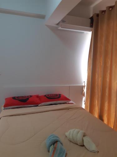 a bed with two towels on it in a room at Avatara Condo B24 by malai in Mae Pim