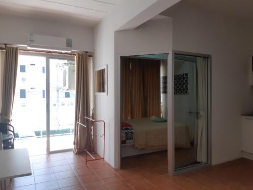 a room with a bedroom with a bed and a mirror at Avatara Condo B24 by malai in Mae Pim