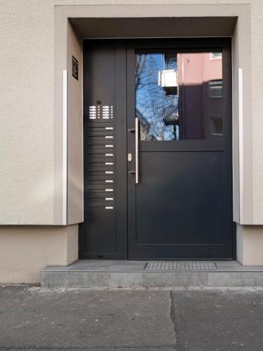 a black door on the side of a building at Limehome Augsburg Pilgerhausstraße in Augsburg
