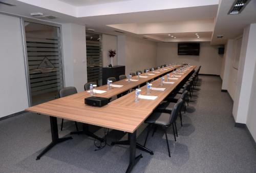 a large conference room with a long table and chairs at Hotel Alexandar II in Skopje