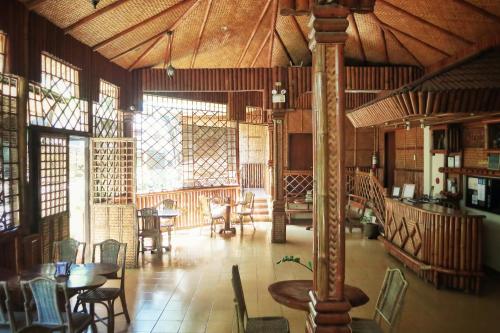 a large room with tables and chairs in a building at Pagdayon Traveler's Inn in Puerto Princesa City