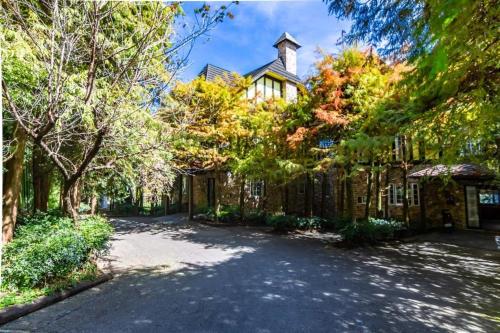 a large house with a driveway in front of it at Provence Rose Lodge in Renai