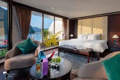 a hotel room with a bed and a table at Mon Chéri Cruises in Ha Long