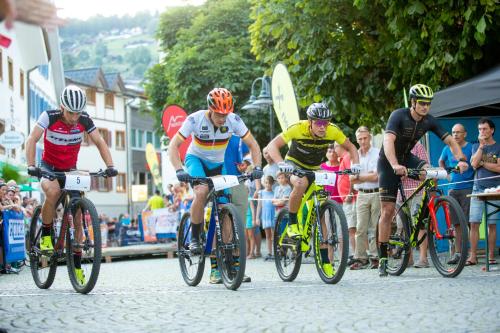 a group of people riding bikes down a street at TUI BLUE Montafon in Schruns-Tschagguns