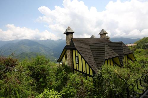 a house with a roof on top of a hill at Provence Rose Lodge in Renai