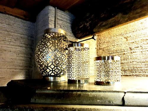 two metal vases sitting on top of a table at Kieppi in Syöte