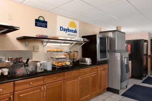 a kitchen with a counter top with food on it at Days Inn by Wyndham Keene NH in Keene