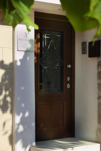 a wooden door with a sign in front of it at Musmelia Rooms in Mussomeli