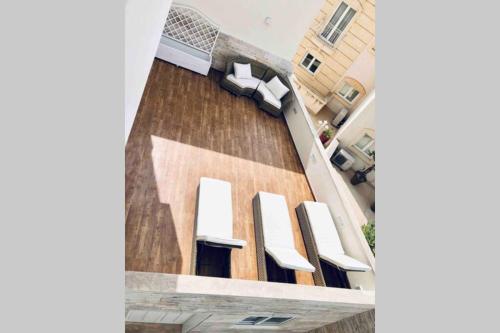 an overhead view of a balcony with white chairs at Modern Luxury villa in St. Julians in St Julian's