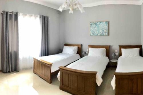 a bedroom with two beds and a window at Modern Luxury villa in St. Julians in St Julian's