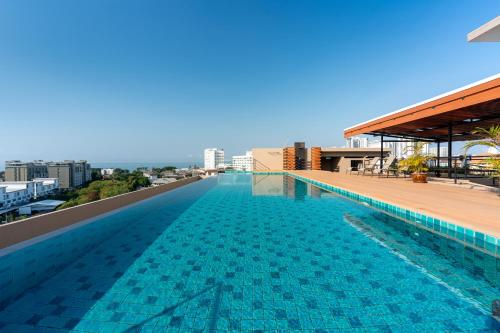 a swimming pool on the roof of a building at LawinTa Hotel Pattaya in Jomtien Beach