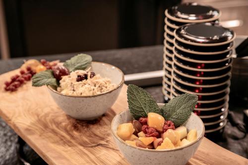 two bowls of fruit and dip on a cutting board at Caramelo Palma Beach in Playa de Palma