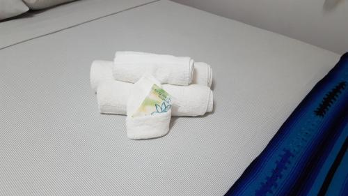 a pile of towels sitting on top of a bed at Nature Resort in Bermudian Landing