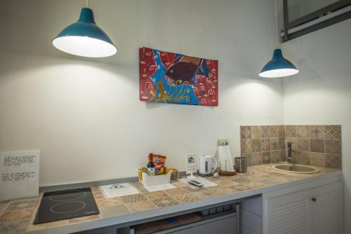 a kitchen with two lights and a counter top at Aretusa Vacanze B&B in Siracusa