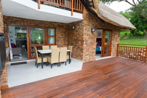 a patio with a table and chairs on a deck at Kruger Park Lodge Unit No. 608B in Hazyview
