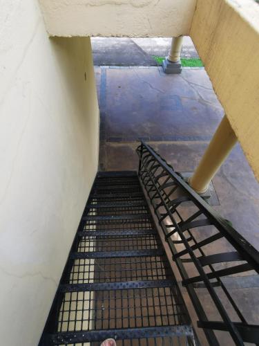a staircase in a building with a metal railing at Floreat Riverside Lodge and Spa in Sabie