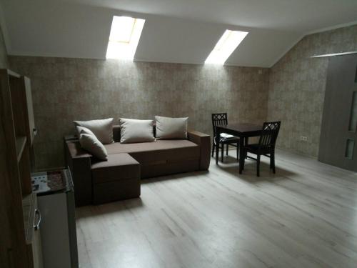a living room with a couch and a table at Згадка in Truskavets