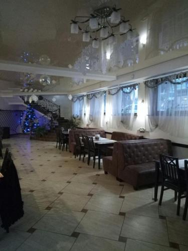 a living room with tables and chairs and a dining room at Згадка in Truskavets