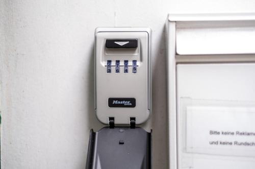 an atm machine is attached to a wall at cruwzo I Apartments in Wuppertal in Wuppertal