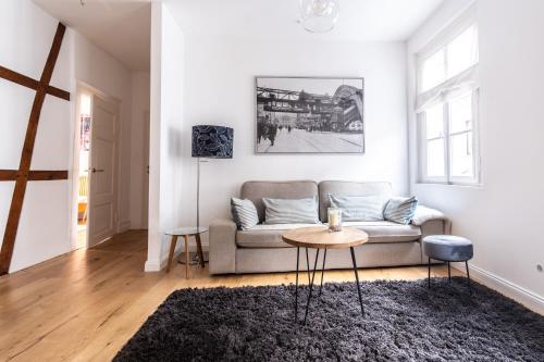 a living room with a couch and a table at cruwzo I Apartments in Wuppertal in Wuppertal