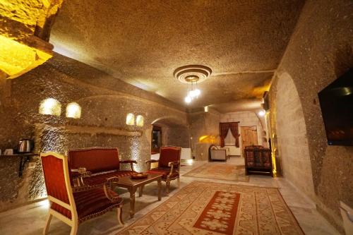 a living room with a couch and chairs in a building at Roma Cave Suite in Goreme