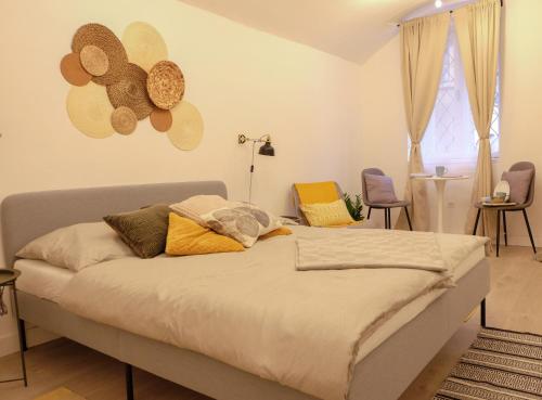 a bedroom with a bed with hats on the wall at STUDIO ELA Centre in Košice