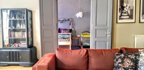 a living room with a couch and a book shelf at SummerStreetSeven in Budapest