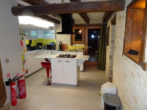 a kitchen with a white counter top in a room at Domaine du Clos de la Touche Parc et Piscine in Chaunay