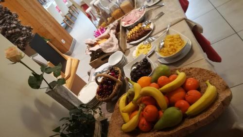 a table with a bunch of fruit on it at Hôtel Restaurant Les Tilleuls in Autrans