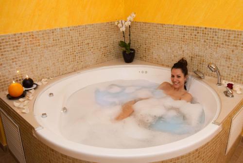 a woman is sitting in a bath tub at Casa Nuri de Rei La Pobla Tornesa in Puebla Tornesa