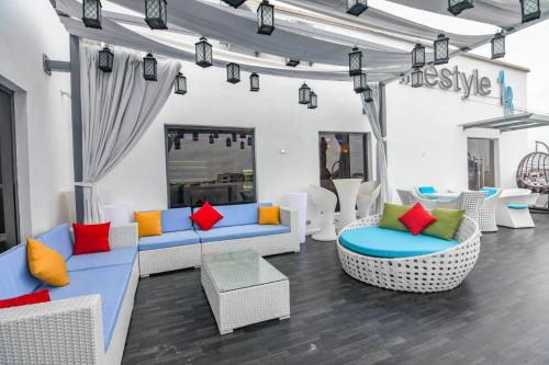 a living room with couches and colorful pillows at Lifestyle18 Hotel and Shortlet Apartments in Lagos
