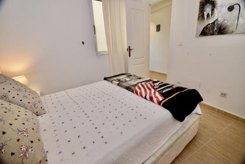 a bedroom with a bed in a room with a cross at 027 La Mata View Natural Park in La Mata