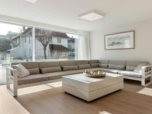 a living room with a couch and a coffee table at Elegant Holiday Home in De Panne with Sauna in De Panne