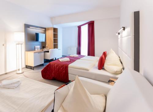 a hotel room with two beds and a bathroom at Hotel Stadtfeld in Magdeburg