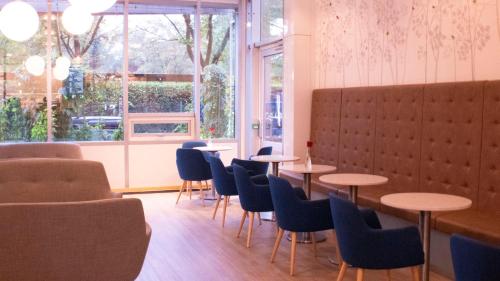a room with tables and chairs and a window at Ullev&aring;l Hotel in Oslo