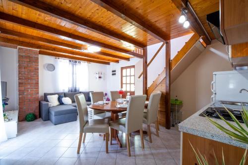 a kitchen and dining room with a table and chairs at Apartment Maja's Style in Vela Luka