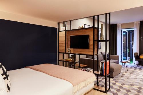 a bedroom with a bed and a tv in a room at Hotel Indigo Antwerp City Centre by IHG in Antwerp