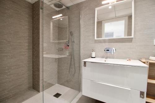 a bathroom with a shower and a sink and a mirror at Beautiful cozy seaside Apartment AQUARELLE in Calpe in Calpe