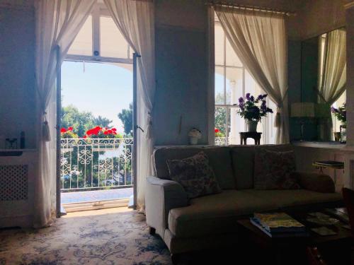 a living room with a couch and a large window at Pier View Self Catering Luxury Apartments in Southend-on-Sea