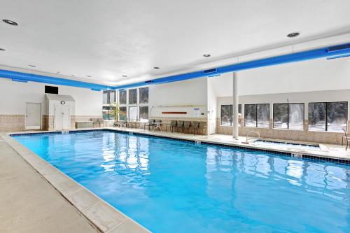 a large swimming pool with blue water in a building at Montezuma Condominiums in Keystone
