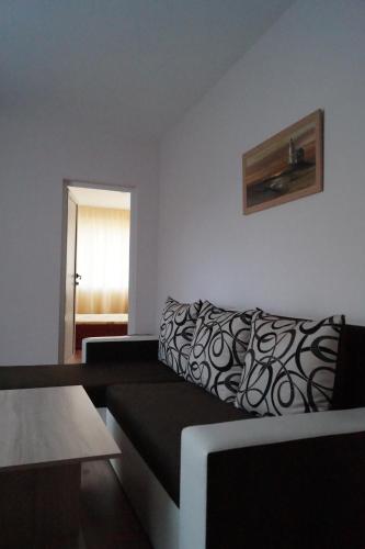 a living room with a couch and a window at Guesthouse Iceberg in Ravda
