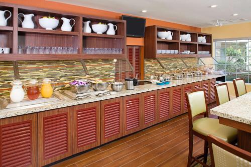 a kitchen with a counter with vases on shelves at Hyatt House Belmont Redwood Shores in Belmont