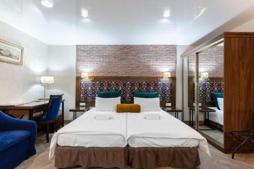Un dormitorio con una cama grande y un sofá azul. en Botanical 21, en Tiflis