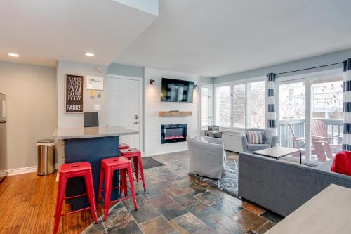 a kitchen with red stools and a bar in a room at Blue Mountain (1 bedroom) Escape at North Creek Resort in Blue Mountains